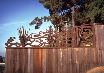 wood fence topped with steel cutouts with Japanese styling