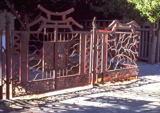 sidewalk view of gate as it turns the corner