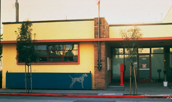 fire station entrance with dog cutout sculpture on blue background