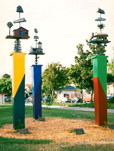  multicolored towers topped with hour sculptures fashioned like weather vanes 