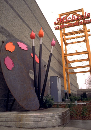 metal sculpture of giant artist's palette and paint brushes 